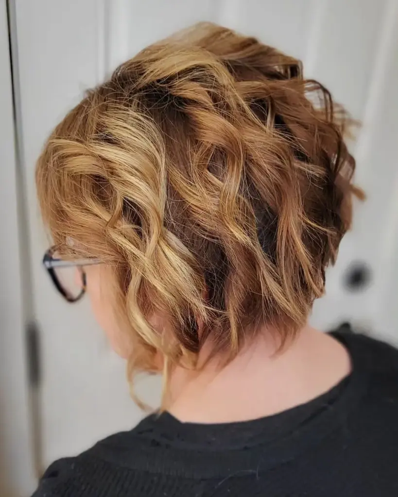 Valovit paž z balayage prameni v toplih karamelnih tonih, ki pomladi in poživi videz.